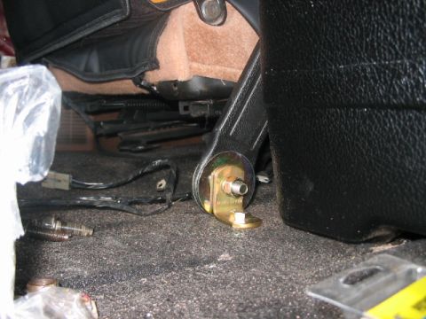 1991 Ford Bronco - The mounting bracket for a vehicle seat is shown attached to the floor with bolts.