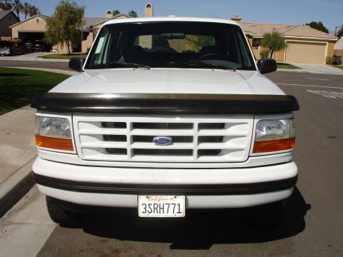1996 Ford Bronco - Front view of a white 1996 Ford Bronco parked on a residential street.