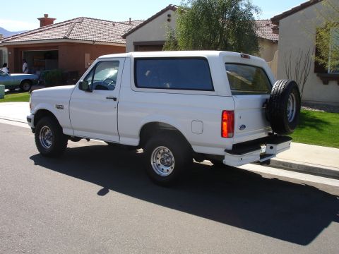 1996 Ford Bronco - This white 1996 Ford Bronco is seen from the rear quarter angle on a sunny day.