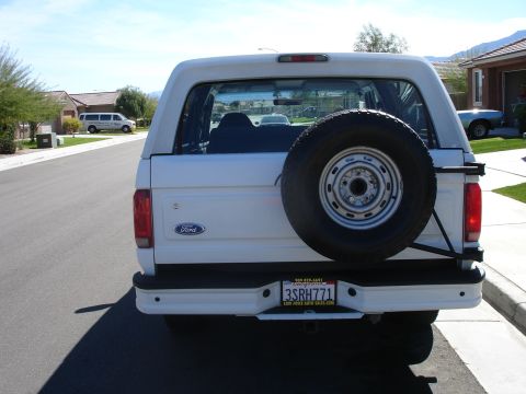1996 Ford Bronco - Rear view of a white 1996 Ford Bronco parked on a suburban street.