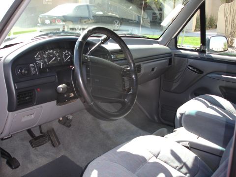 1996 Ford Bronco - Interior view of a truck's dashboard and seats, showing the steering wheel and instrument cluster.