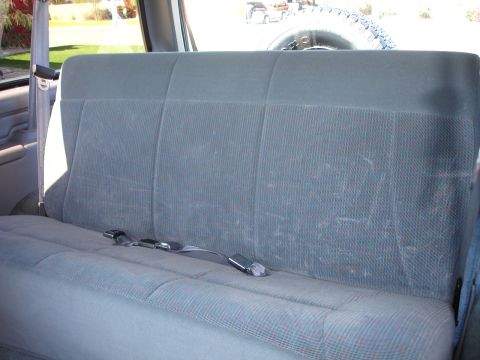 1996 Ford Bronco - Interior view of a 1996 Ford Bronco, showing the rear seat and spare tire.