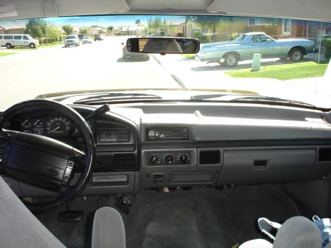 1996 Ford Bronco - Interior view of a 1992 Ford F-150, showing the dashboard and a light blue El Camino parked outside.