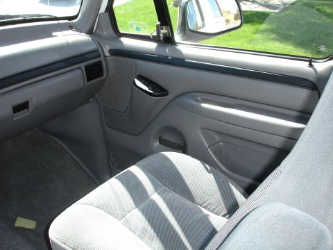 1996 Ford Bronco - Interior view of a vehicle, showing the seat and door panel.