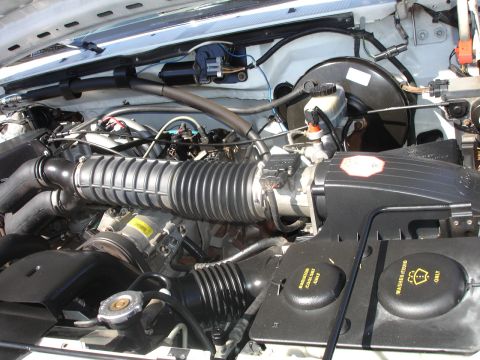 1996 Ford Bronco - Close-up view of the engine bay, showing the air intake system and various fluid reservoirs.