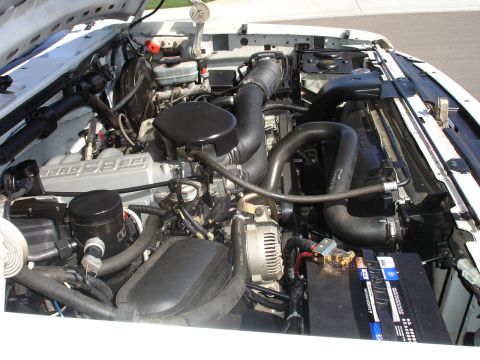 1996 Ford Bronco - Engine bay of a 1996 Ford Bronco, showing the V8 engine and associated components.