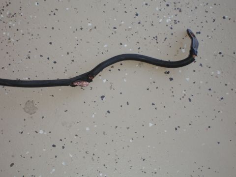 1996 Ford Bronco - A damaged electrical wire with exposed copper is visible on a speckled floor, suggesting a repair or damage issue.