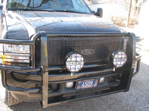 2003 Ford Excursion - This 2003 Ford Excursion features a heavy-duty grille guard and auxiliary PIAA lights, enhancing its appearance.