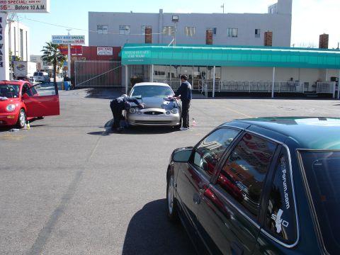 1993 Ford Taurus - A silver sedan, possibly from the early 2000s, is being detailed at a car wash.