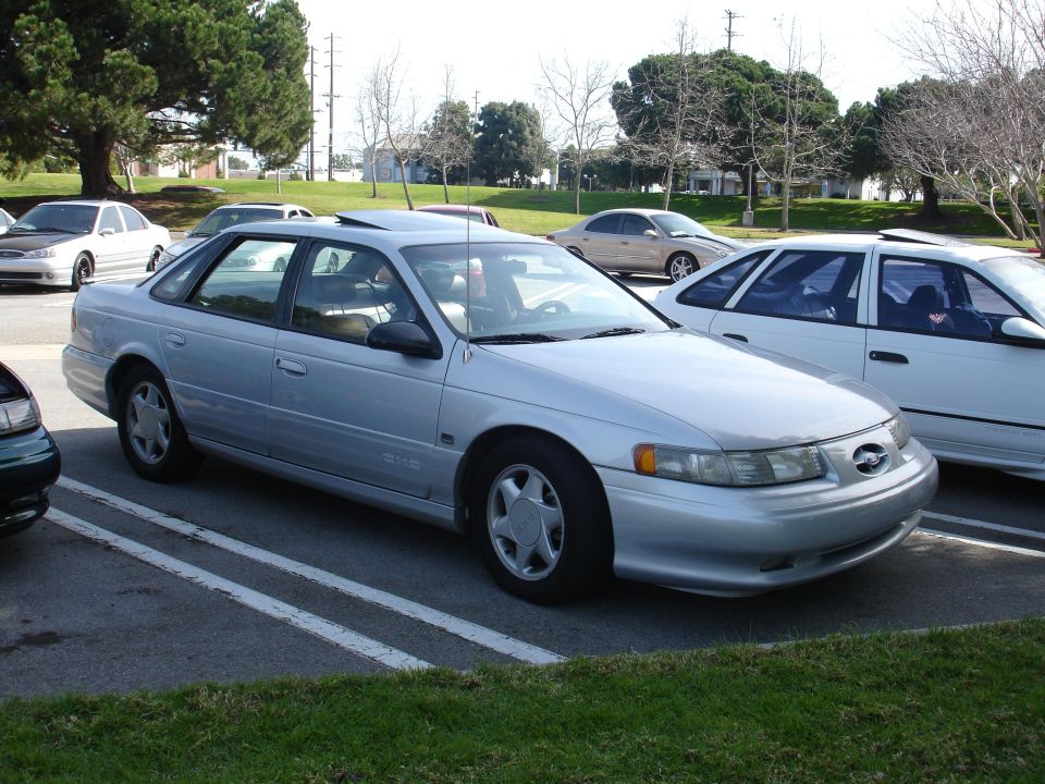 Silver 1993 Ford Taurus sedan parked in a lot, 3q-front view