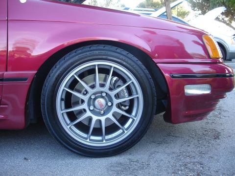 1993 Ford Taurus - This 1993 Ford Taurus features aftermarket wheels and performance brake calipers, visible from the front quarter panel view.