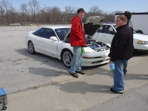 1993 Ford Probe - A white 1993 Ford Probe is shown with its hood open, while two men stand around it.