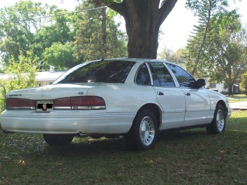1997 Ford Crown Victoria - Rear view of a white 1997 Ford Crown Victoria parked on grass.
