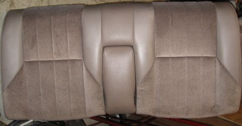 1993 Ford Thunderbird - A close-up view of a car's rear seat, showing its fabric upholstery and center armrest.
