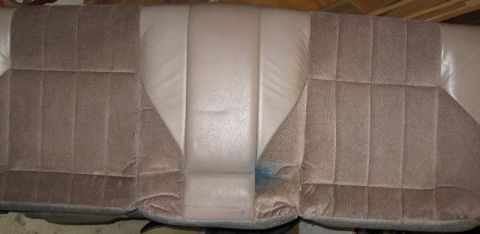 1993 Ford Thunderbird - Close-up of the interior seats of a vehicle, showing fabric upholstery and a small blue stain.
