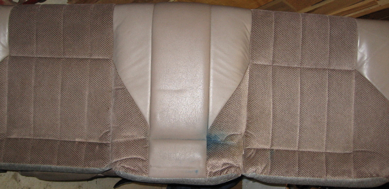 Tan fabric car seats with a blue stain on the right side