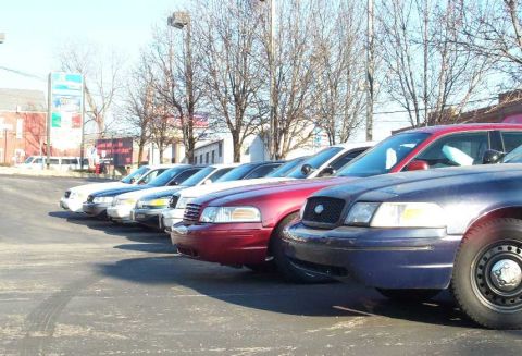 1998 Ford Crown Victoria - Several Ford Crown Victoria police cars are parked in a row on a sunny day.