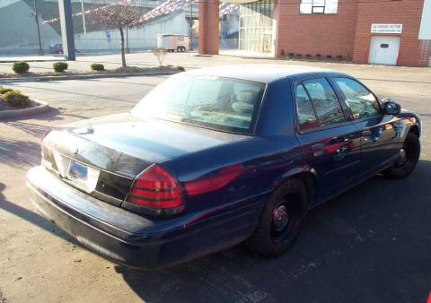 1998 Ford Crown Victoria - Rear view of a dark blue 1998 Ford Crown Victoria sedan parked on asphalt.