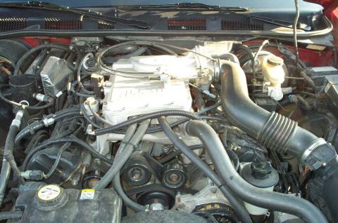 1998 Ford Crown Victoria - The engine bay of a vehicle, various engine components and a visible Supermotors.net logo.