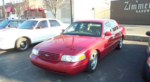 1998 Ford Crown Victoria - 1998 Ford Crown Victoria in red, parked alongside a white Crown Victoria.