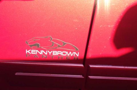 1998 Ford Crown Victoria - A red car door displays a 'Kenny Brown Panther' decal, indicating a custom modification rather than a specific model year.
