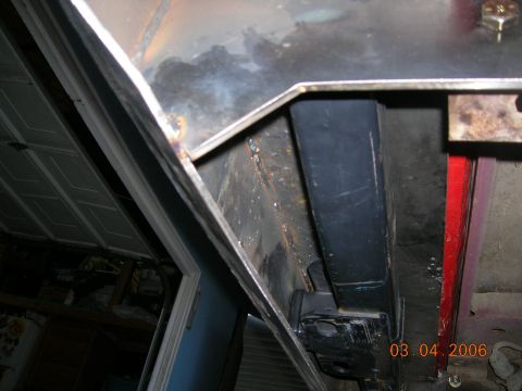 1985 Ford Bronco - Close-up view of a vehicle's undercarriage, showing metalwork and structural components.