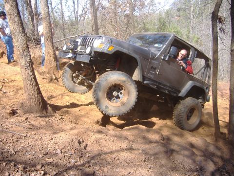 2004 Jeep Wrangler - Jeep TJ navigating a challenging off-road trail with significant articulation.