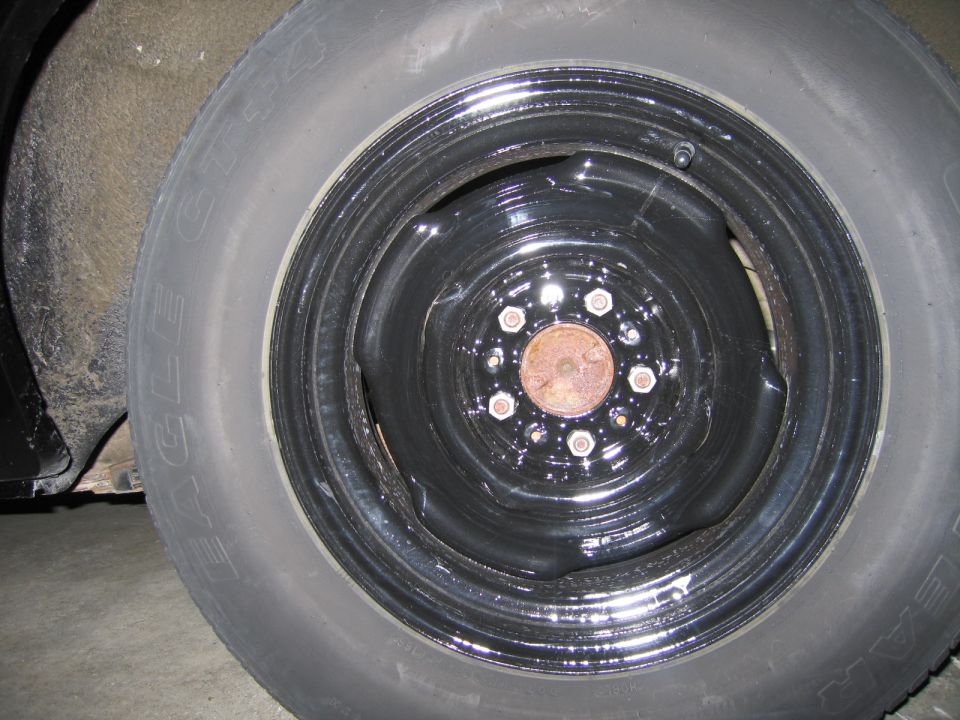 Goodyear Eagle GT tire on a black steel wheel with exposed lug nuts