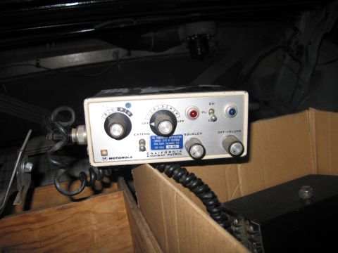 1991 Ford LTD Crown Victoria - Motorola control head labeled California Highway Patrol, with squelch and volume knobs and a coiled handset cord.