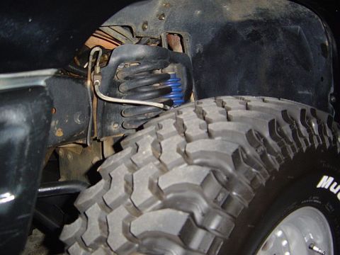 1989 Ford Ranger - This image shows the suspension and a large off-road tire of a truck, not a 1989 Ford Ranger.