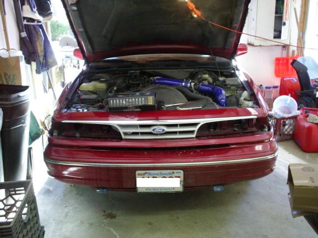 1995 Ford Crown Victoria front view, hood open showing engine bay. Massachusetts license plate visible
