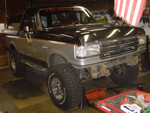 1989 Ford Bronco - This modified Ford Bronco, likely from the late 1980s, is undergoing some form of modification or repair.