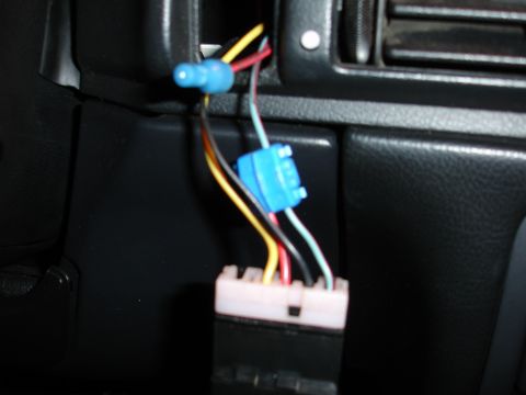 1993 Ford Taurus - Close-up view of exposed wiring and connectors within a vehicle's dashboard area.