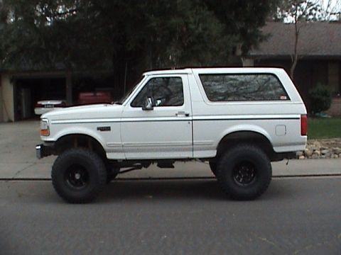 1994 Ford Bronco - This lifted 1992 Ford Bronco features a side profile view with large off-road tires.