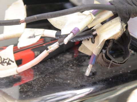 1993 Ford C-350 (Centurion Conversions) - Close-up of a vehicle's wiring harness, showing exposed wires and tape.