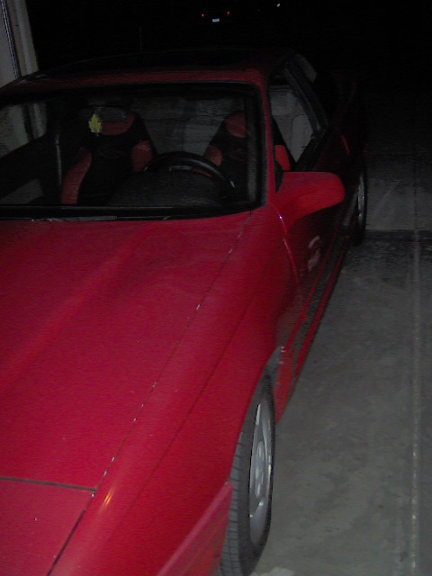 1996 Ford Probe - A red coupe is parked indoors, showing its interior and front quarter panel.