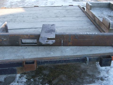 1990 Chevrolet Suburban - Close-up of a trailer frame showing a metal bracket and stamped identification numbers.