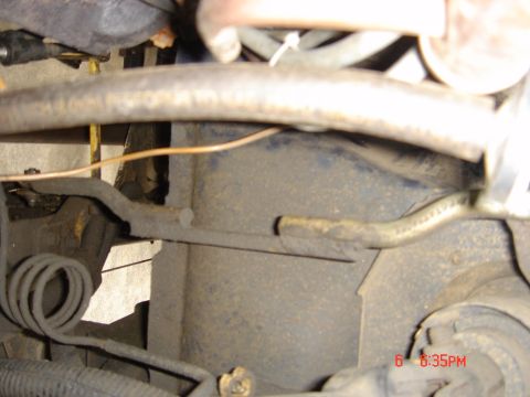 1991 Ford Bronco - This image shows a close-up view of various mechanical components, including suspension parts and hoses, within a vehicle.