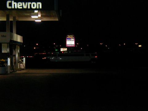 1994 Ford Explorer - A long white limousine is parked at a gas station under a Chevron sign at night.