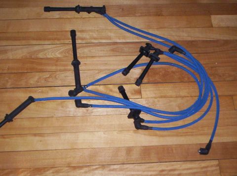 1993 Ford Probe - Blue spark plug wires laid out on a wooden floor.