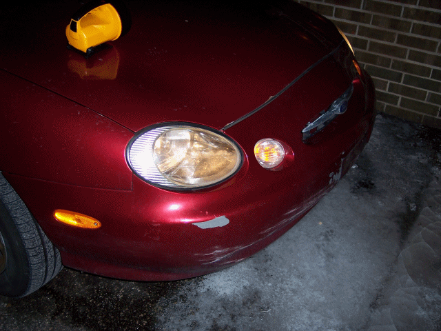 red car headlight and front fender detail
