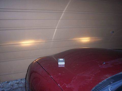 1999 Ford Taurus - The rear of a red vehicle is visible with a blurry background.