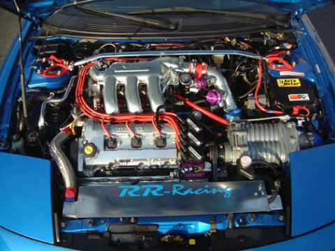 1995 Ford Probe - Customized engine bay a supercharger and performance modifications.