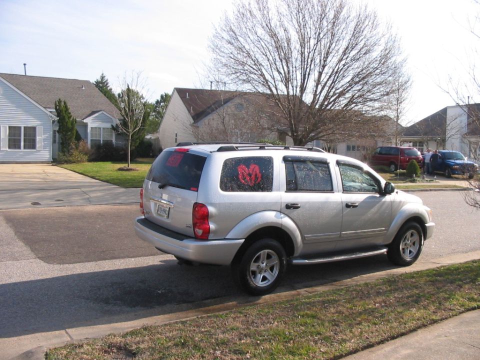 Silver Dodge Durango SUV parked at curb in a suburban neighborhood