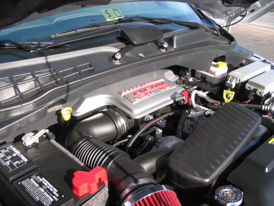 Hemi engine bay with red cone air intake and silver valve covers, hood up