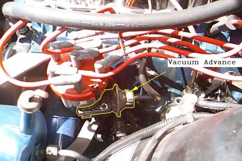 1985 Ford Bronco - Close-up view of an engine bay, focusing on the distributor and vacuum advance system.