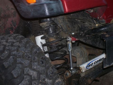 1998 Jeep TJ - Jeep suspension parts, including a Pro Comp shock absorber and coil spring, are visible.