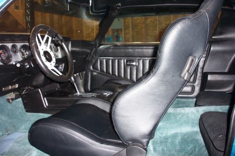 1979 Pontiac Trans Am - The interior of a classic car features bucket seats and a detailed dashboard with gauges.