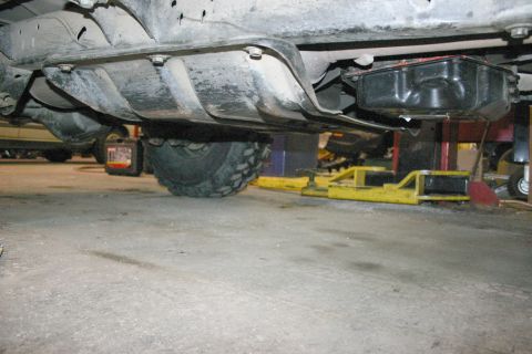 2003 Jeep TJ - Undercarriage view of a vehicle, focusing on skid plates and the transmission pan.
