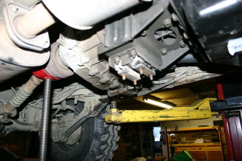 2003 Jeep TJ - Close-up of vehicle undercarriage, showing transmission and exhaust system components.